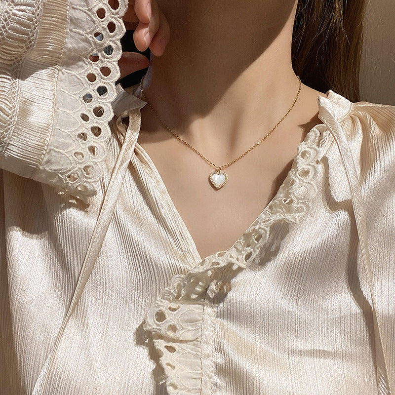 TIDEA Amour Pendant featuring a delicate gold-toned heart necklace with a luminous shell inlay worn on a model