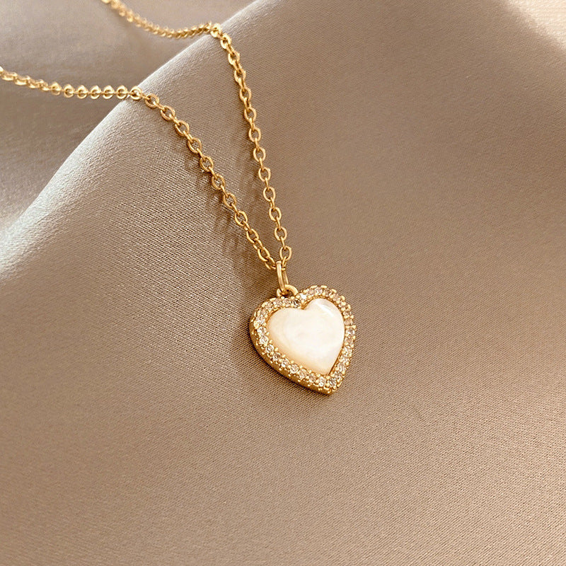 TIDEA Amour Pendant featuring a gold-toned heart charm with a white shell inlay on a delicate chain